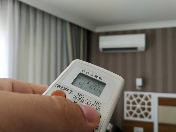 Remote control setting temperature for air conditioner on the wall - Photo, Image