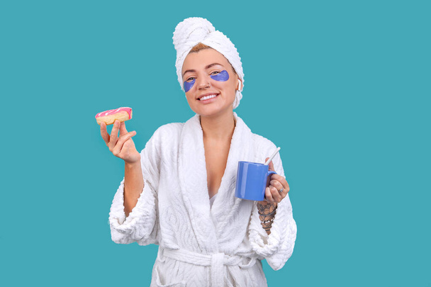 blonde girl in a bathrobe and with patches on her face - Photo, Image
