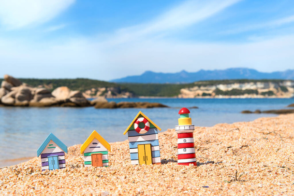 Coast with miniature wooden village and light house - Photo, Image