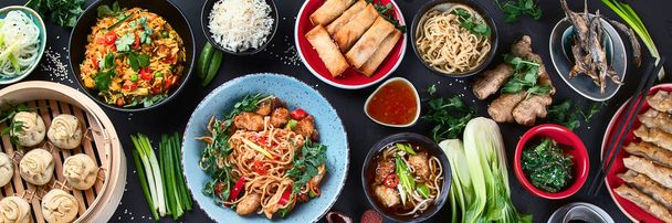 Assorted Chinese food on dark background. Asian food concept. Top view.  Panorama, banner - Foto, afbeelding