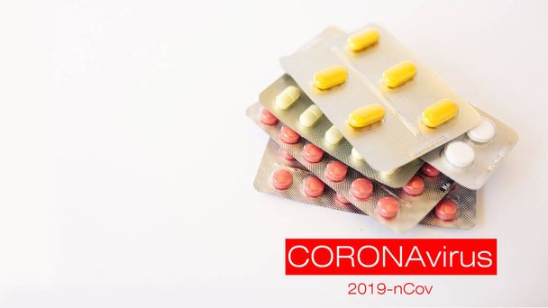 Pills on the table. Coronavirus treatment concept. 2019 nCoV Coronavirus originating in Wuhan, China - Фото, изображение
