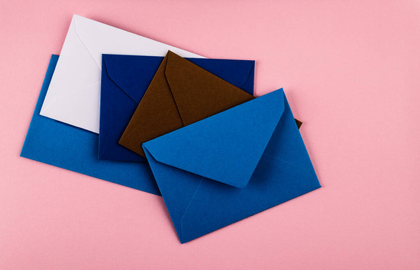 Colorful envelopes on a pink background. Mail envelopes on the table. - Photo, Image