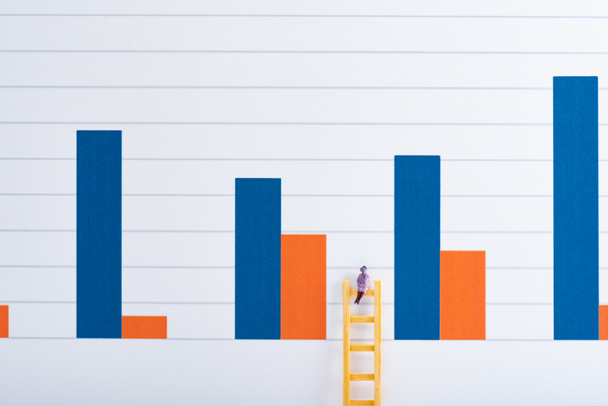 People figure on ladder near blue and red graphs at background, equality concept - Foto, Imagem