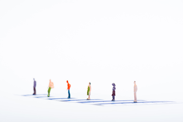 Selective focus of people figures on blue charts isolated on white, concept of equality - Foto, Bild