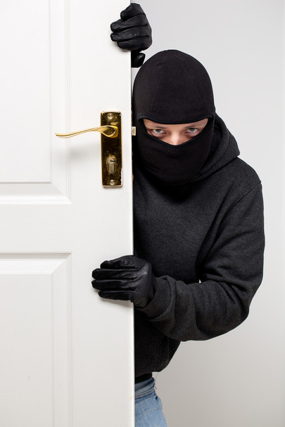 Burglar sneaking in a open house door - Фото, зображення