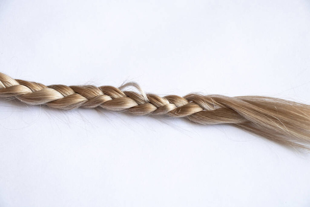 blond hair braid on an isolated background close-up - Photo, Image