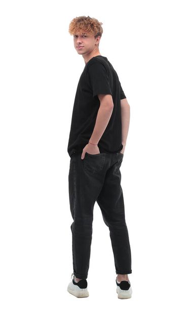 rear view. a man in a black t-shirt looking at the camera - Фото, зображення