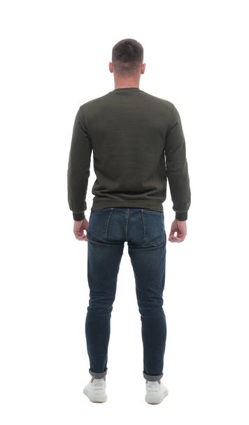 rear view. a young looking male standing in front of a blank white screen - Foto, Imagen