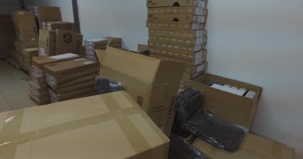 China, Hong Kong - March 2nd 2020.  Aliexpress editorial video with boxes of various manufacturers in the background, and the Aliexpress in the foreground with prep for send. The recording was not made in a warehouse but in a staged environment. - Footage, Video