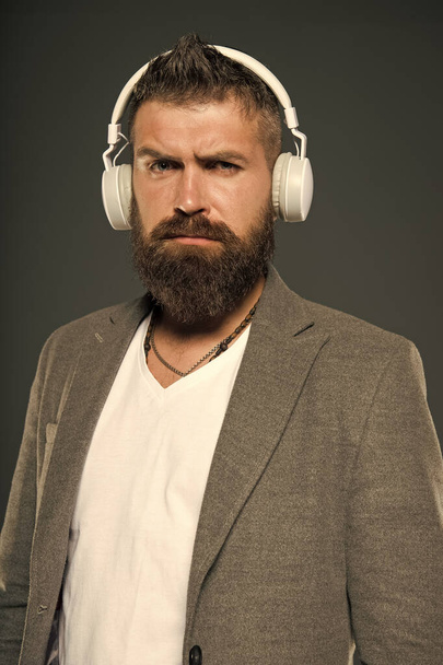 Lifestyle music fan. Man listening music wireless headphones. Hipster use headphones gadget. Inspiring song. Music library. Bearded guy enjoy music. Audio book. Application for listening books - Photo, Image