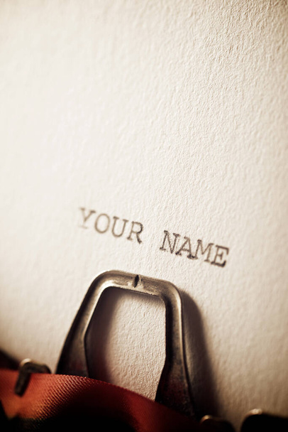 De zin, jouw naam, geschreven met een typemachine. - Foto, afbeelding