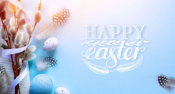 Art Happy Easter risen;  Easter eggs, Spring Flowers and bird feather on blue background; Holiday Easter banner or greeting card background - Zdjęcie, obraz