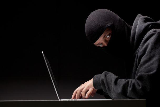 Computer hacker in a balaclava - Foto, imagen