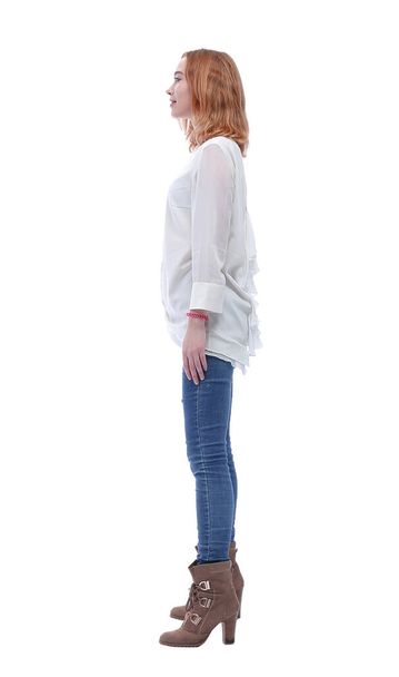 boczny widok. pewna siebie modna młoda kobieta w dżinsach i wysokich butach - Zdjęcie, obraz