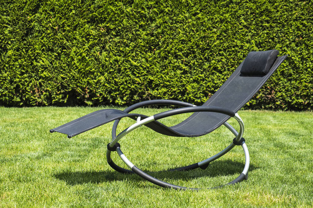 Rocking lounger on a green grass. Relaxing time. Summer time - Photo, Image