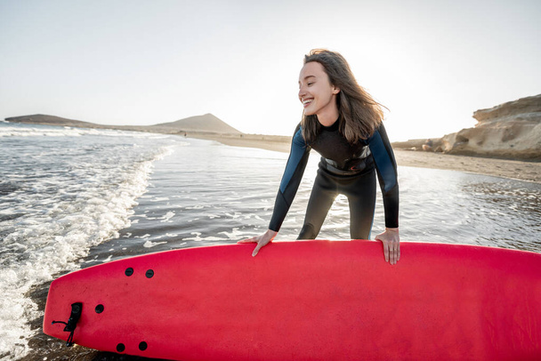 Joven surfista con tabla de surf en la playa
 - Foto, Imagen