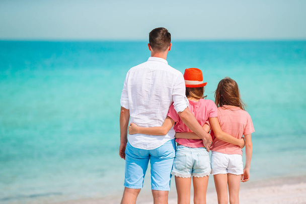 Πατέρας και παιδιά απολαμβάνουν τις καλοκαιρινές διακοπές στην παραλία - Φωτογραφία, εικόνα