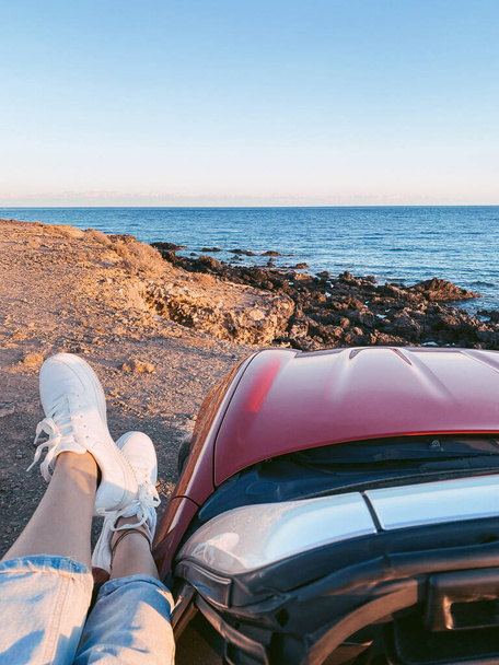 Woman traveling on car near the ocean - Photo, Image