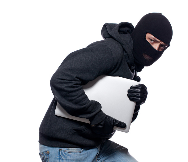 Thief stealing a laptop computer - Foto, Imagen