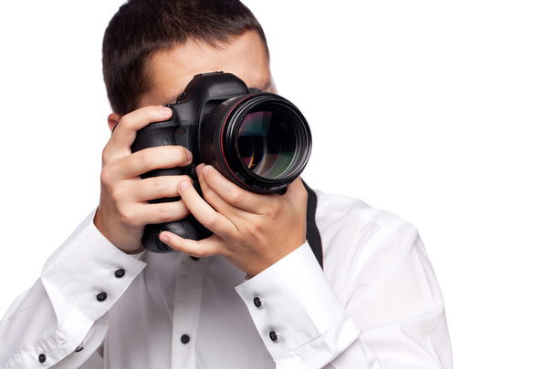 Young man taking photo with professional camera - Zdjęcie, obraz