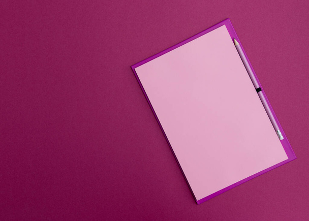 Pink notebook with pink pencil on a pink background. - Foto, immagini