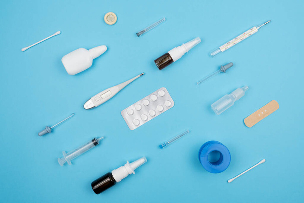 Assortment of medical supplies on a blue background. The view from the top. - Photo, image