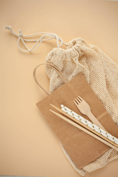Natural eco accessories for life. A paper bag, bamboo sticks, paper tubes, a bag made of thread. Eco. - Foto, imagen