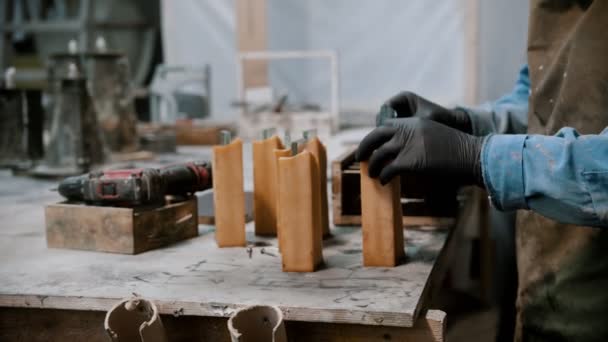 Concrete industry - man preparing glass and silicone for the working on the souvenir statue - Materiał filmowy, wideo