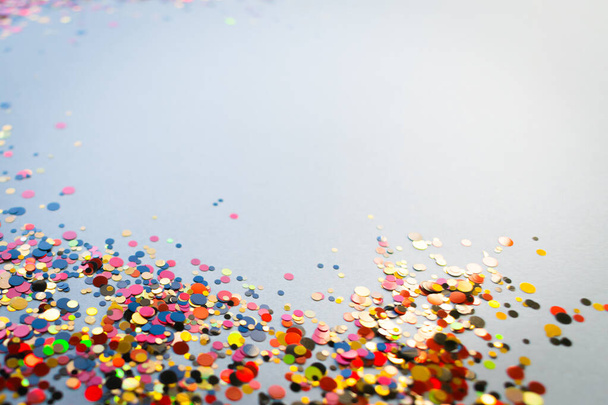 Confetti background, shiny dots bright colours on grey background, festive colours in focus - Foto, imagen
