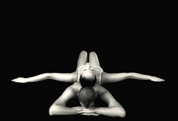 yoga pose. black and white photo of a young woman in a swimsuit. - Фото, зображення
