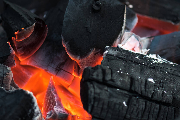 Charcoal embers burning with fire and ashes preparing for a spring and summer barbecue - Fotoğraf, Görsel