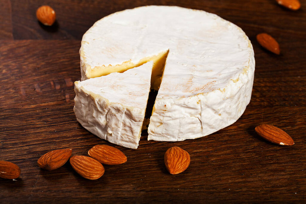 Camembert cheese or brie on wooden background. - Photo, Image