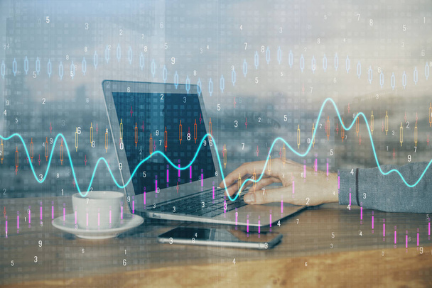 Double exposure of stock graph with businessman typing on computer in office on background. Concept of hard work. - Valokuva, kuva