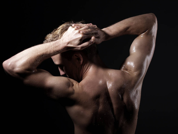 muscular man with naked torso on black background - Photo, Image