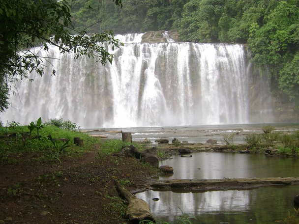 Tinuy-an Falls reflected in a pool of water. Tinuy-an Falls is a top attraction in Surigao del Sur, Philippines. - Photo, Image