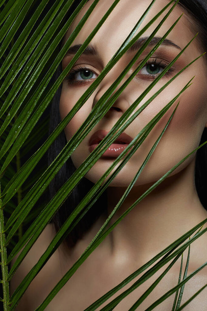  beautiful girl in palms. Beautiful woman with Make-up. Beauty Portrait. wild woman in Jungle. - Photo, Image
