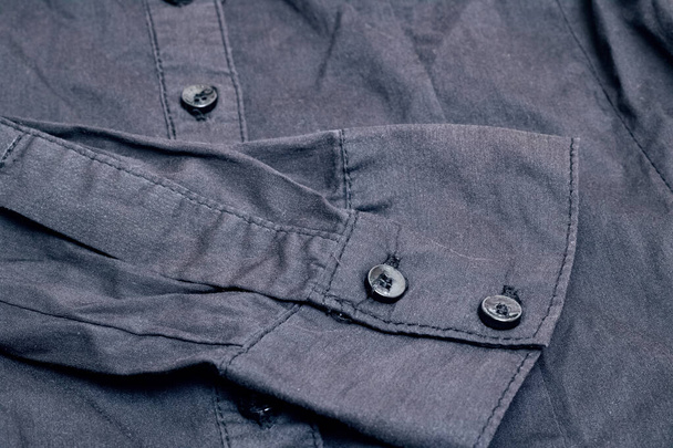 Buttons on a black shirt close up, macro photo - Photo, image