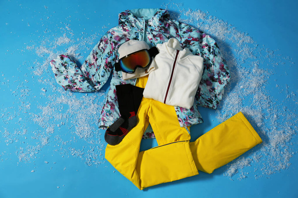 Stylish winter sport clothes on light blue background, flat lay - Foto, Imagen