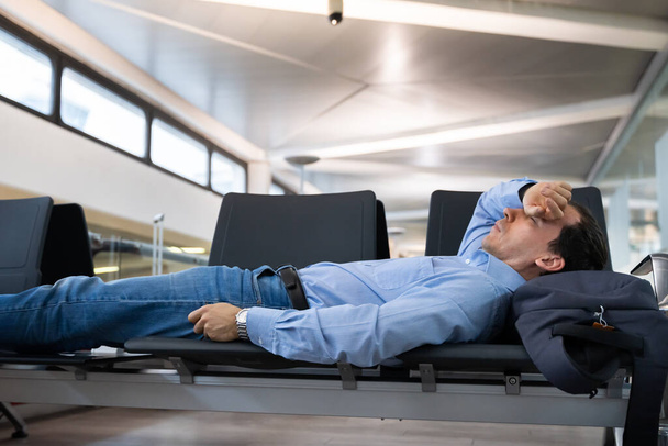 Delayed Flight. Man Sleeping In Airport Terminal - Zdjęcie, obraz