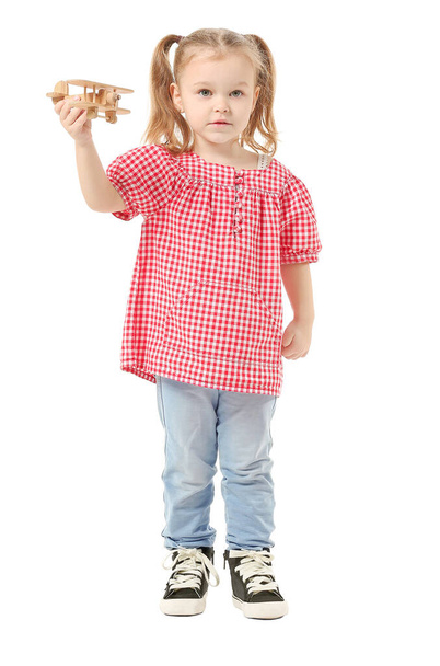 Cute little girl with toy airplane on white background - Photo, Image