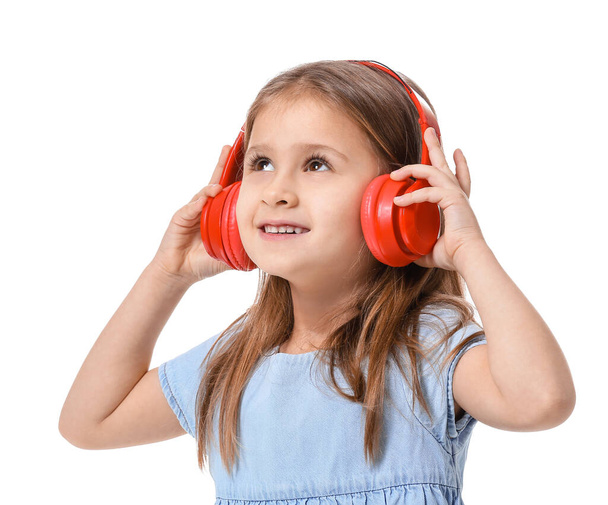 Cute little girl listening to music on white background - Photo, Image