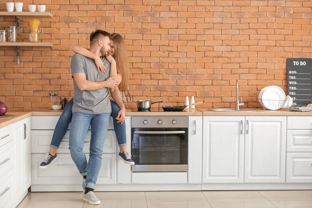 Happy young couple in kitchen - Foto, Imagem