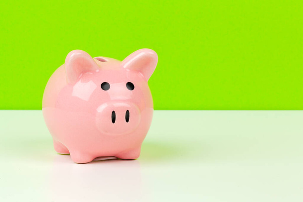 piggy bank on color background. creative photo. - Foto, afbeelding