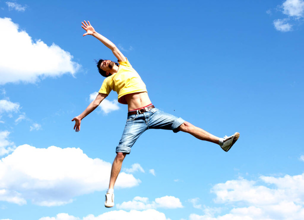 happy and free man on blue sky background with clouds - Fotó, kép