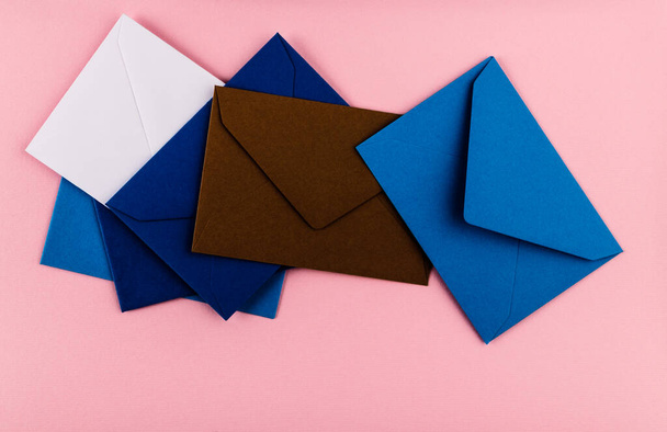 Colorful envelopes on a pink background. Mail envelopes on the table. - Fotó, kép