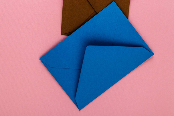 Colorful envelopes on a pink background. Mail envelopes on the table. - Fotó, kép