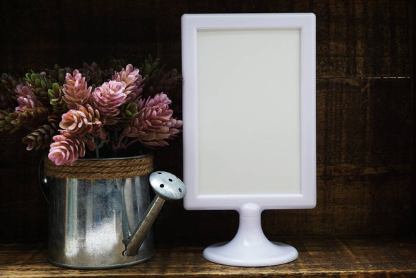 Blank Display frame stand with artificial plant home decoration on wooden background - Fotografie, Obrázek