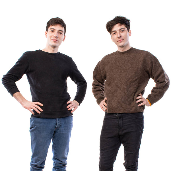 Two handsome young men posing on a white background. Twin brothers - Photo, Image