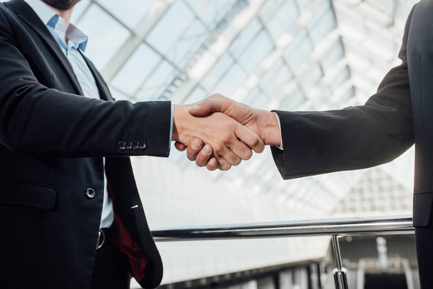 Businessmen making handshake in the office, business etiquette, congratulation, merger and acquisition concepts, panoramic banner - Фото, зображення