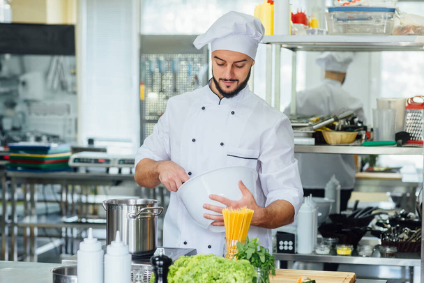 Cooking food, profession and people concept, happy male chef cook at restaurant kitchen. - Φωτογραφία, εικόνα